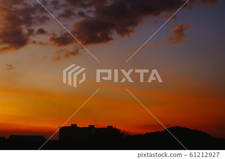 Silhouette of Beautiful sunset with Building. Orange sky with sun and clouds. Nature background. Silhouette of Beautiful sunset with Building. Orange sky with sun and clouds. Nature background. 61212927