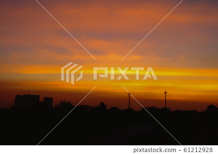 Silhouette of Beautiful sunset with television antenna or telecommunications towers have a lot of different antennas, Orange sky with sun and clouds. Nature background. 61212928