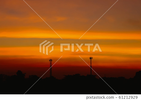 Silhouette of Beautiful sunset with television antenna or telecommunications towers have a lot of different antennas, Orange sky with sun and clouds. Nature background. Silhouette of Beautiful sunset with television antenna or telecommunications towers have a lot of different antennas, Orange sky with sun and clouds. Nature background. 61212929