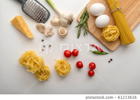 Ingredients for pasta cooking on white background 61213616