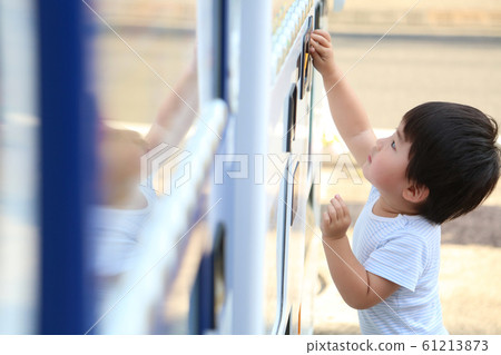 Boy using a vending machine Boy using a vending machine 61213873
