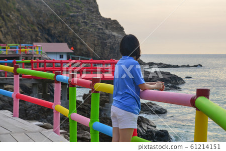 An Asian woman enjoying the sea 61214151