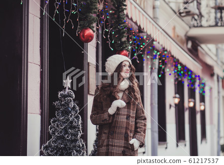 happy woman in mittens and knitted hat 61217537