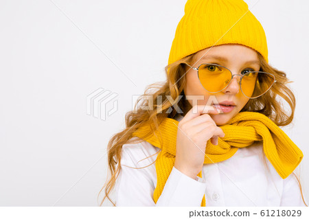 close-up portrait of an attractive smiling girl in a yellow hat and sunglasses, in a white shirt close-up portrait of an attractive smiling girl in a yellow hat and sunglasses, in a white shirt 61218029