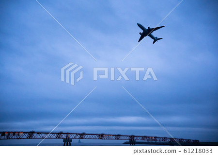 Airplane taking off in cloudy sky Airplane taking off in cloudy sky 61218033