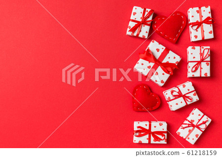 Top view of gift boxes and red textile hearts on 61218159