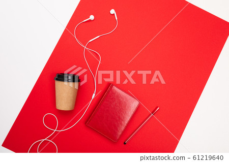 minimalism concept. paper cup and notebook with pen on a red background with copy space 61219640