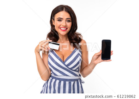 Pretty caucasian woman holds a credit card and mobile phone isolated on white background 61219862