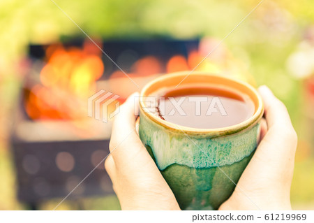 Hands holding tea cup. 61219969