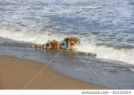 Fishing nets swept to the shore by waves 61220264