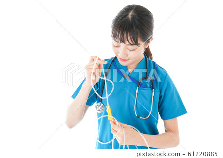 Smiling young nurse using drip 61220885