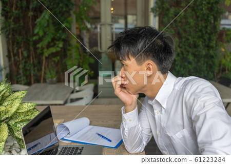 Young businessman in white shirt worry about work Young businessman in white shirt worry about work 61223284