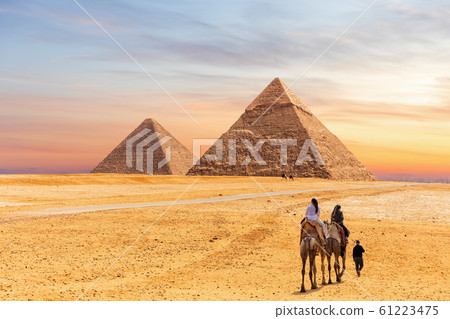 Egyptian Pyramids of Giza and the tourists on a camel 61223475