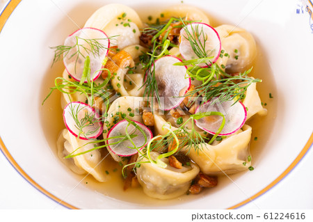 Meat broth with dumplings, radish and greens 61224616