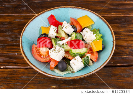 Greek salad, with cheese and fresh vegetables with seasonings Greek salad, with cheese and fresh vegetables with seasonings 61225584