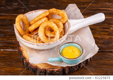 Onion rings in meatballs, served with mustard sauce Onion rings in meatballs, served with mustard sauce 61225675