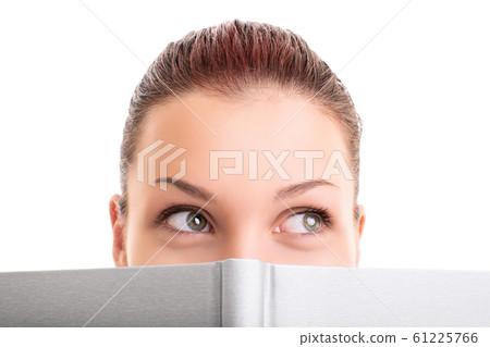 Girl hiding behind a notebook 61225766