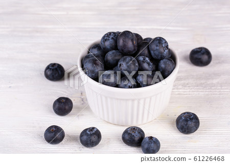 Large blueberry on white wooden background in plaid 61226468