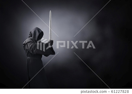 Ghostly figure with medieval sword in the dark Ghostly figure with medieval sword in the dark 61227828