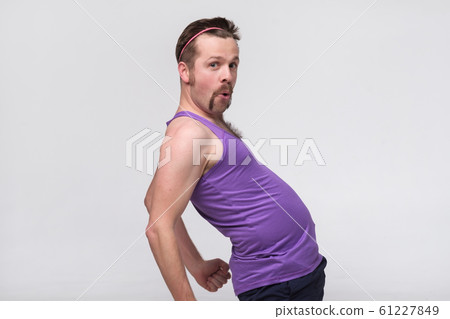 Handsome fit young funny bearded man being proud tha he is awesome at sport 61227849