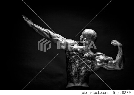 Back view of tattoed bodybuilder with outstretched arms Back view of tattoed bodybuilder with outstretched arms 61228279