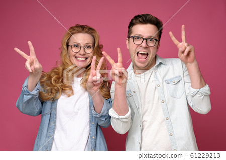 Mature caucasian couple showing two fingers and taking a selfie 61229213