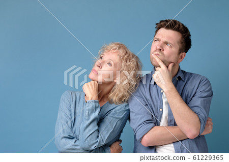 Caucasian family mother and som looking up standing over blue smiling. 61229365