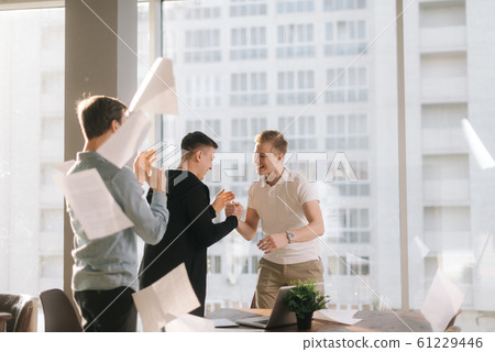 Successful business team are having fun throwing paper documents 61229446