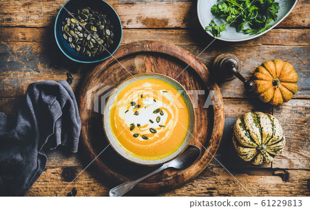 Pumpkin soup with seeds, parsley and cream in 61229813