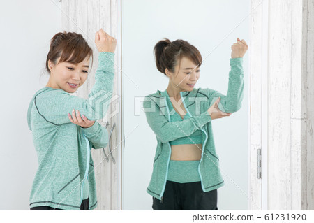 Woman checking body with mirror 61231920