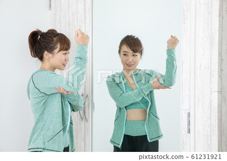 Woman checking body with mirror 61231921