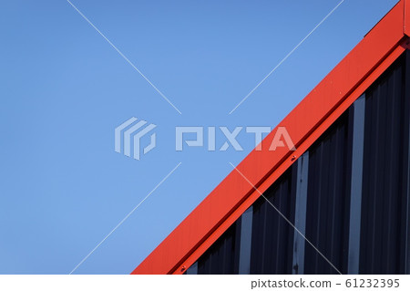Black and red metal steel plate for background. Blue sky background. 61232395