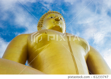 Golden buddha of statue on blue sky background Golden buddha of statue on blue sky background 61233747