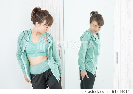Woman checking body with mirror Woman checking body with mirror 61234015