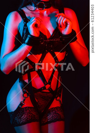 body girl in the leather sword-belt and stockings, with her hands in handcuffs for BDSM sex 61234403