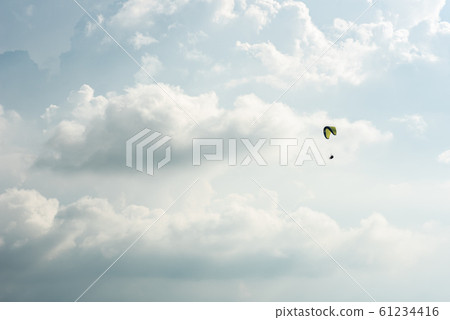 colorful paragliding over blue sky colorful paragliding over blue sky 61234416