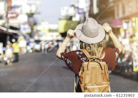 Young woman with hat traveling in Khao san street Young woman with hat traveling in Khao san street 61235903