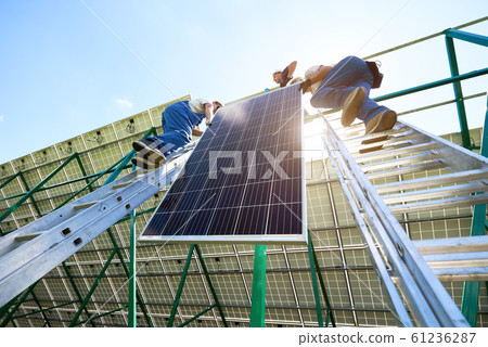 Solar battery screen installing by two mounters. Solar battery screen installing by two mounters. 61236287