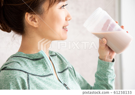 Woman drinking protein Woman drinking protein 61238133