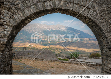 Stone Arch with a view of fortress ruins in Gjirokaster, Albania 61239697