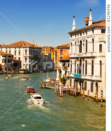 Panorama of Grand canal with boats and gondolas on sunny summer day in Venice. Italy 61240356
