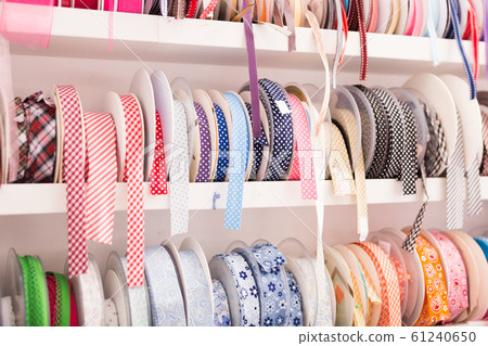 Colorful ribbons on counter in store 61240650