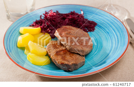 Veal steak with potato and sauerkraut 61240717