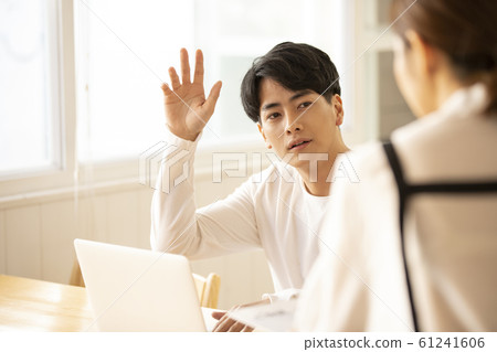 A man working at a cafe 61241606