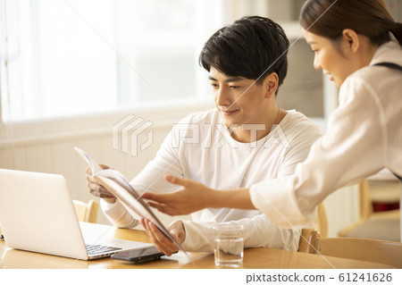 A man working at a cafe 61241626