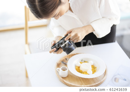 Woman taking a picture of sweets 61241639