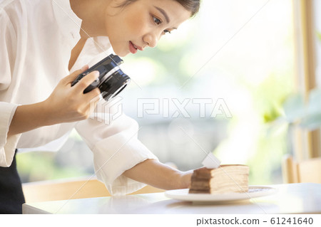 Woman taking a picture of sweets 61241640