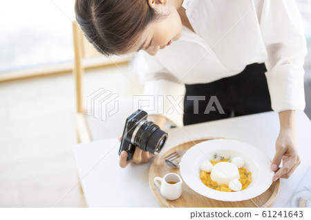Woman taking a picture of sweets Woman taking a picture of sweets 61241643