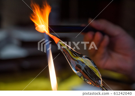 Artist works on glass with fire Artist works on glass with fire 61242040