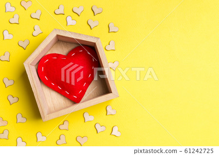 Top view of red textile heart in a wooden house 61242725